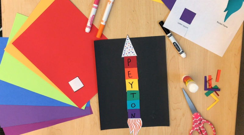 Overhead shot of Name Rocket activity made up of colorful paper shapes and writing your name