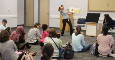 Library staff presenting storytime to a room of families at Parr Library
